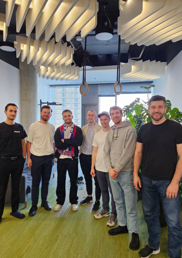 Ivan standing with a group of founders in an office