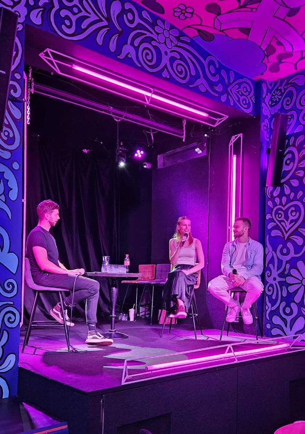 Ivan speaking on stage with two fellow panelists
